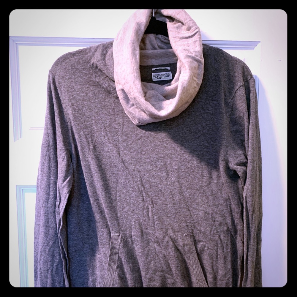 A turtleneck sweater with oversized cowl neck.